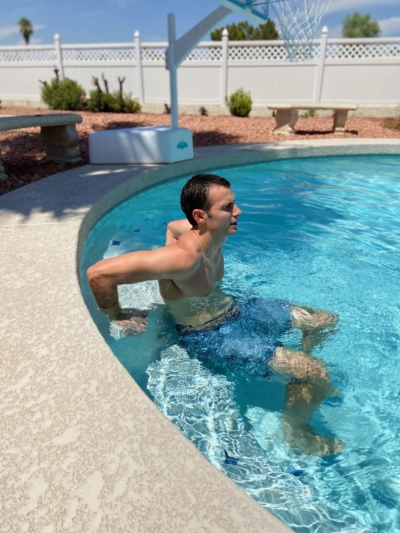 A man doing Deck Dips in a pool