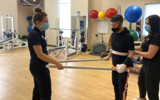 Physical therapy tech helping a patient with exercises