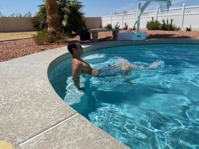 A man doing Bicycle Kicks in a pool