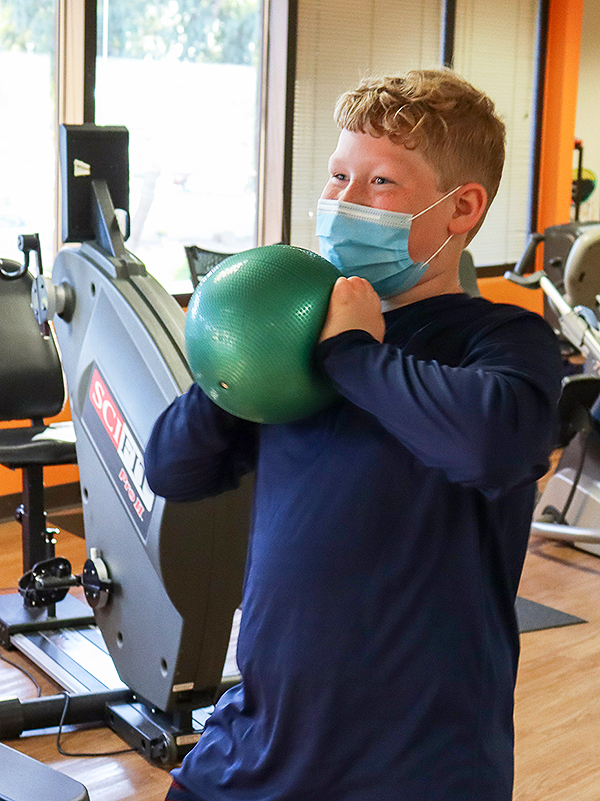 A teen doing a chest squeeze.