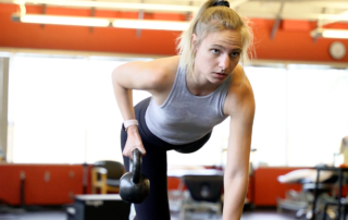 Molly Ahlemeier, CSCS lifting a kettlebell.