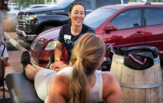 Maria Kline treating a runner just before a marathon.