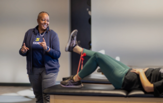 Stefanie with a patient doing leg kicks.