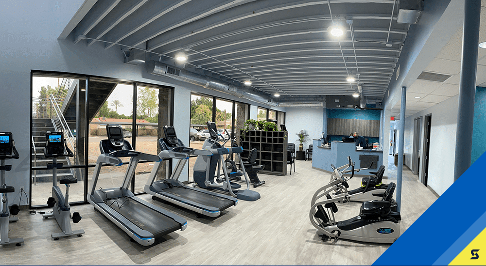 Row of treadmills, ellipticals, and bikes at Spooner Sunnyslope