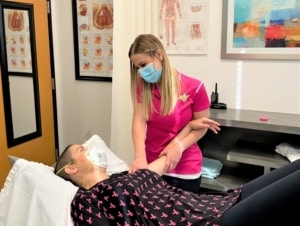 Patient seeing a physical therapist for Beast Cancer rehabilitation