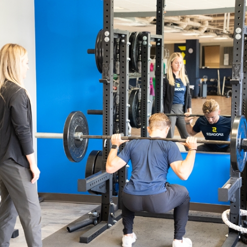 Image of a man performing a squat press.