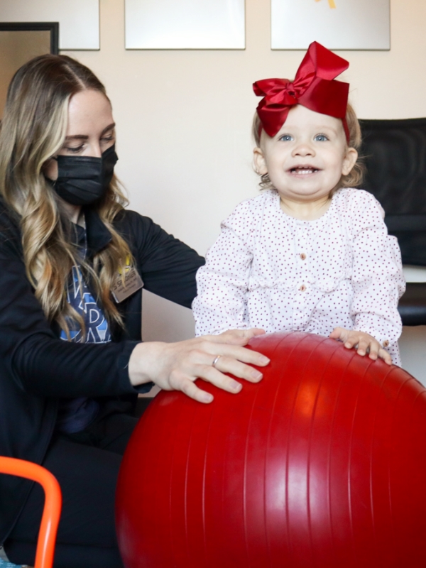 Image of a toddler on a bosu ball.